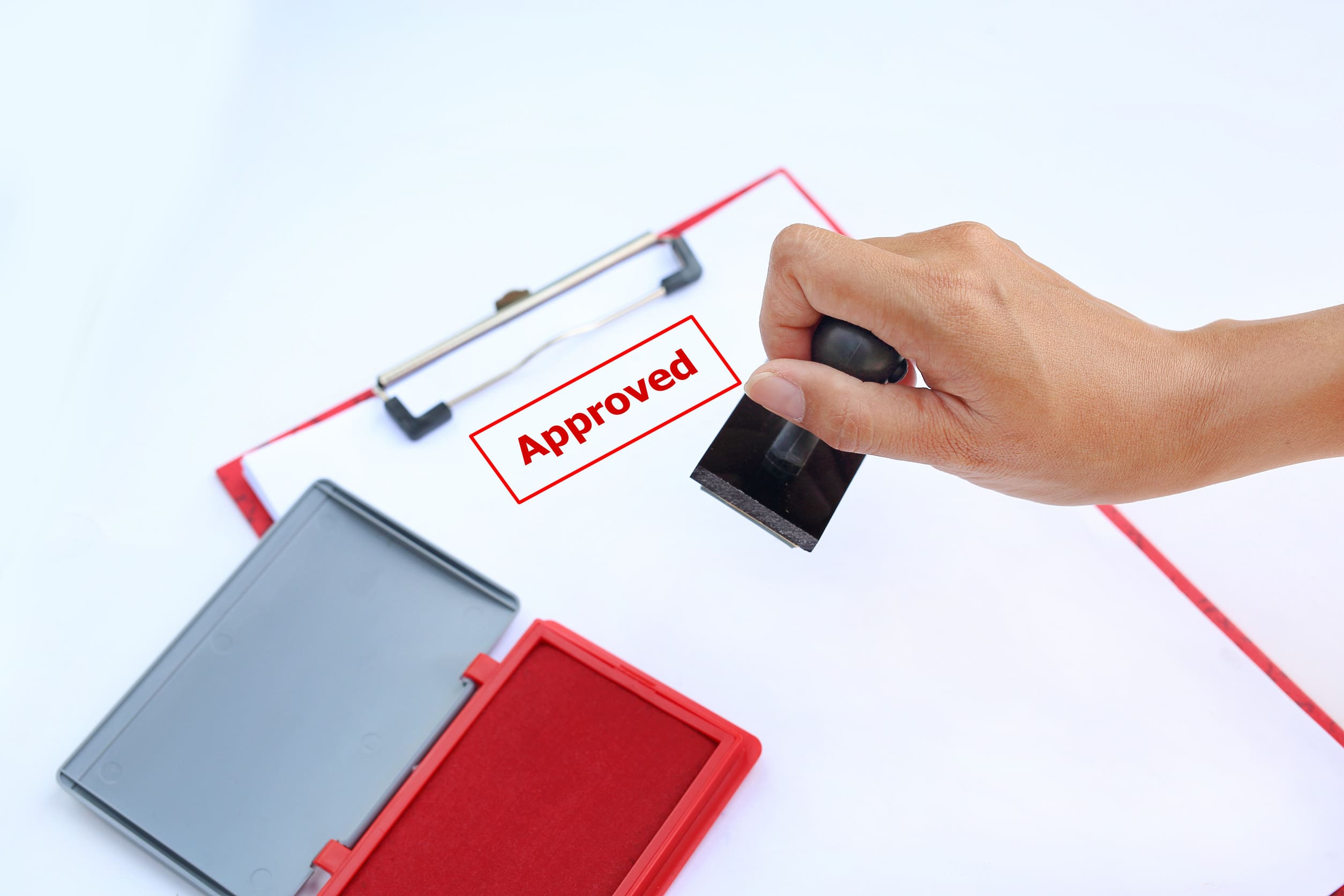 Hand Stamping Approved On Paper Sheet With Red Ink Pad Box