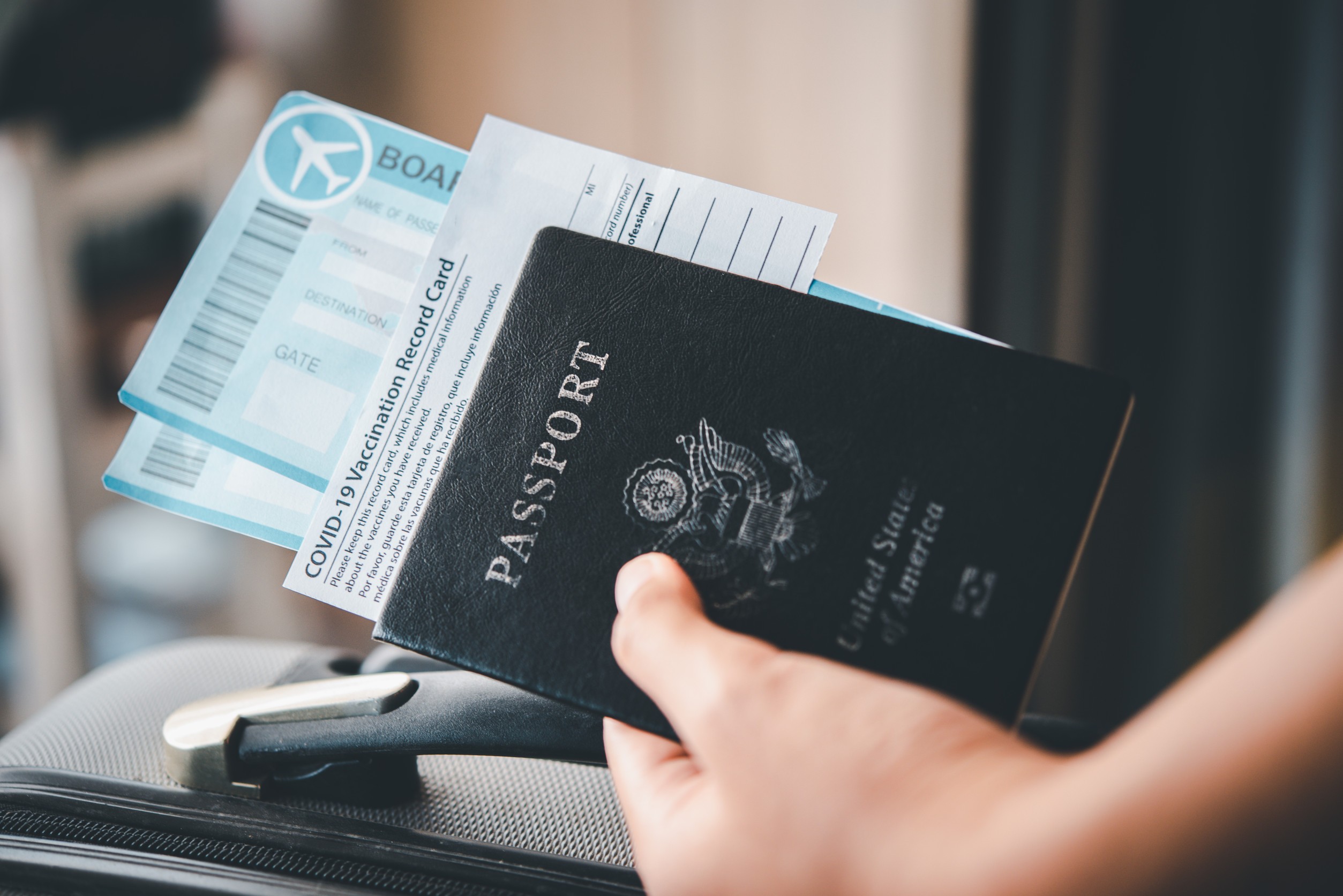 People Holding Passports And Coronavirus Vaccination
