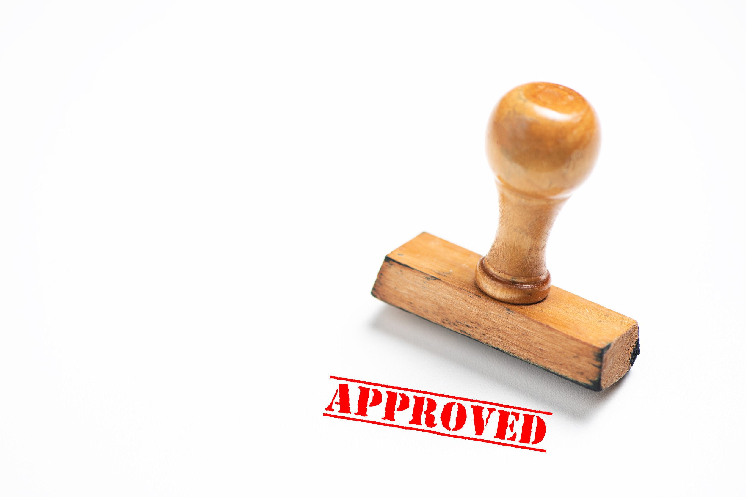 Rubber Stamp With Approved Sign On White Background Close Up