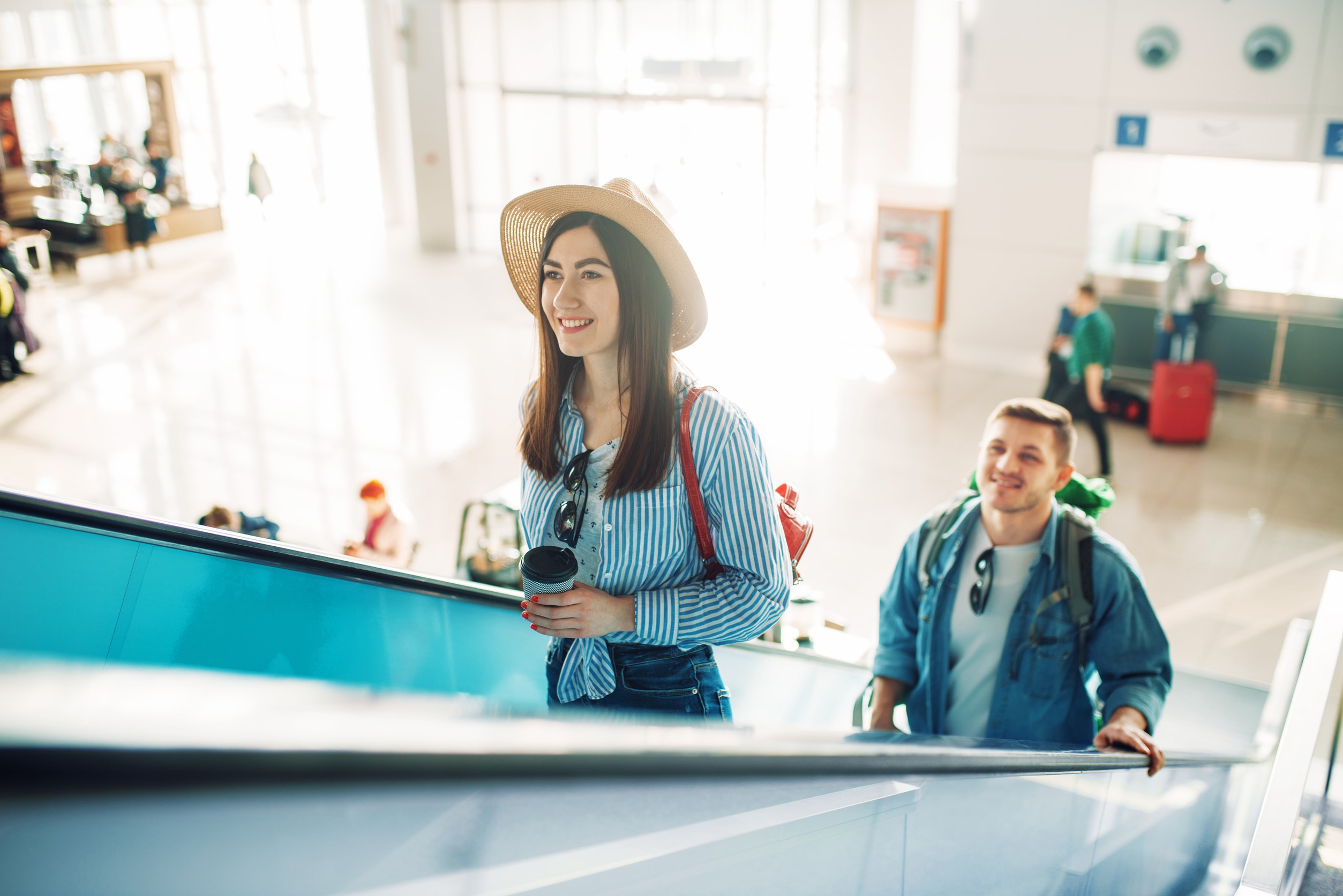Tourists With Luggage Climb The Escalator Airport
